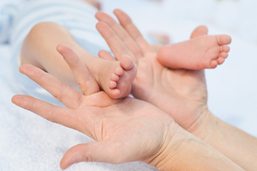 Obraz na płótnie Canvas Baby feet in mother's hands