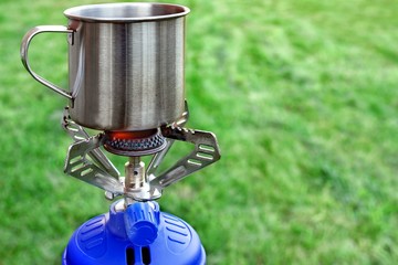 Camp Gas  Stove and steel tea mug.
