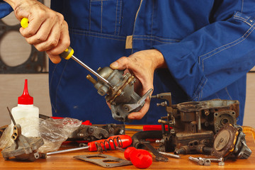 Mechanic repairing parts of the automotive engine