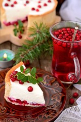 Cheese cake with cranberries on a wooden table