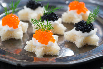 Christmas appetizers with bread and caviar, close-up