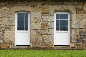 Modernisierte Granitfassade mit zwei Kunststofftüren