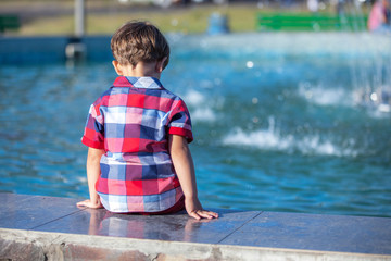 child boy  near the fountain