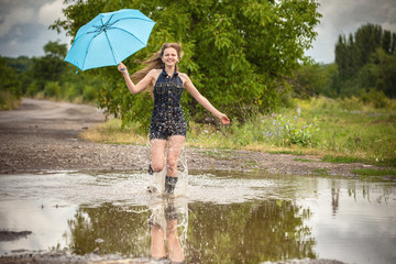 pretty young woman in the rain with umbrella