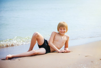 Fototapeta na wymiar boy on a beach in sand