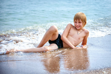 boy on a beach in sand