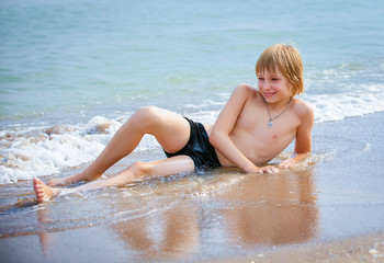 boy on a beach in sand © liandstudio