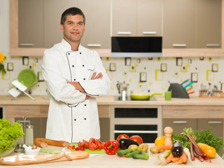 confident chef standing in kitchen