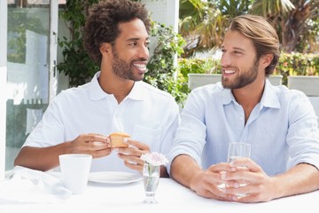 Happy friends enjoying coffee together