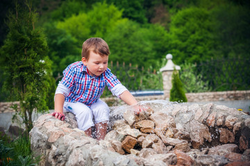 boy near the fountain in summer