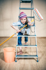 happy little girl on a folding ladder