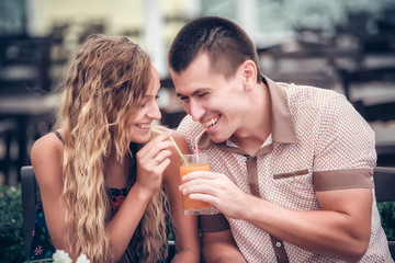 young couple with drinks in cafe outdoor, summer day
