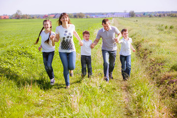 Young happy family in a field