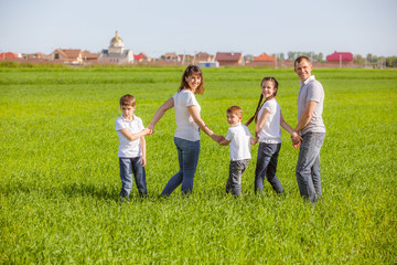 Young happy family in a field