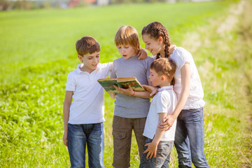 children enjoying reading on a sunny summer day