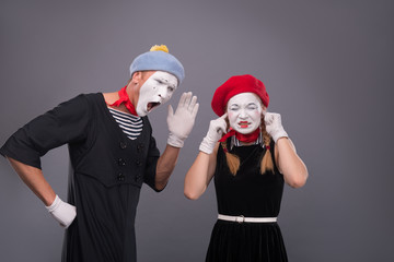 Portrait of funny mime couple with white faces and emotions isol