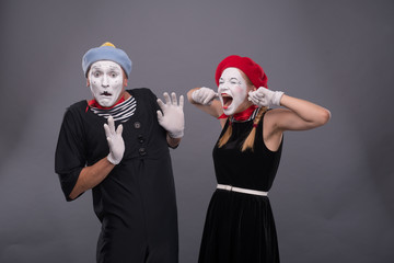 Fototapeta na wymiar Portrait of funny mime couple with white faces and emotions isol