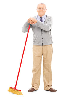 Senior Man Holding A Broom