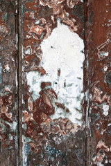 Old door with a face drawn in cracked paint