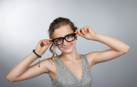 teen girl corrects glasses