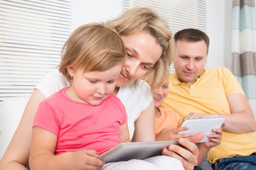 Young Family Using Tablet Together