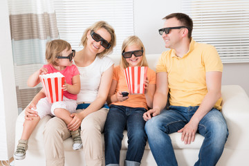 Young Family Watching 3D TV