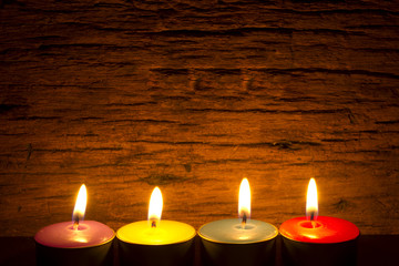 burning tea candle in night