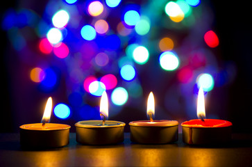 burning tea candle in night