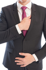 Elegant caucasian male model reaching his interior suit pocket.