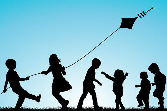 Group of children silhouettes with a kite outdoor