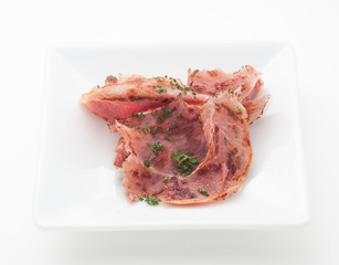 Sliced ham on white plate