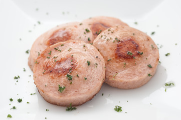 Fried sausage on white plate