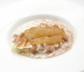 Oatmeal with milk and apple jam in a white plate