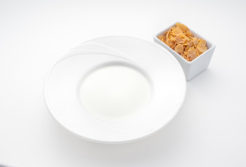 Plate of milk and oatmeal isolated on white
