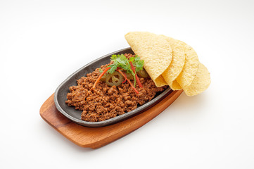 Fried minced lamb meat with loaf on a hot plate