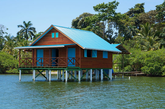 Bungalow on stilts over water of the Caribbean sea