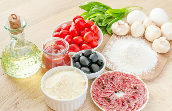 Ingredients for pizza on the wooden background