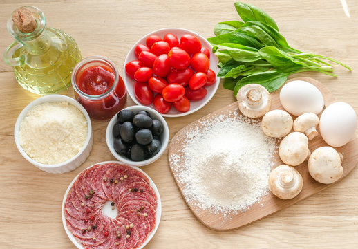 Ingredients for pizza on the wooden background