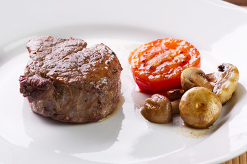 Meat with mushrooms and tomato
