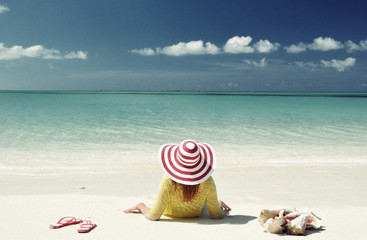 Fototapeta na wymiar Girl relaxing on the beach of Exuma, Bahamas