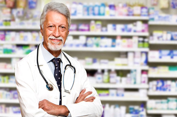 portrait of a male pharmacist at pharmacy