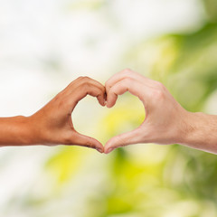 woman and man hands showing heart shape