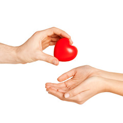 man hand giving red heart to woman