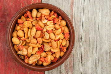 bowel of peanuts on grungy wood background