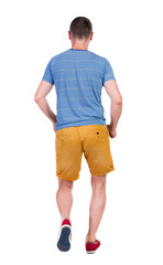 Back view of running man in t-shirt and shorts