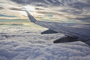 Sunset, clouds and wing