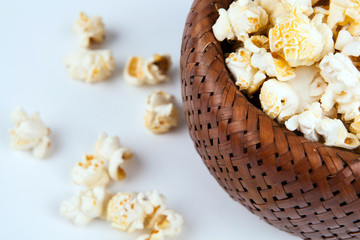 lot of salt popcorn into a bamboo bowl