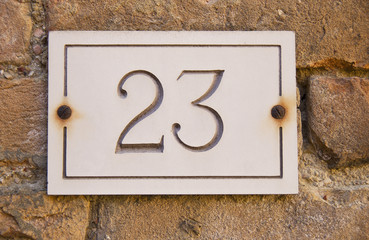 Brass Door Number 23 Mounted on Stone Facade