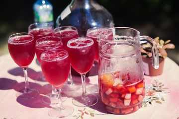 Beautiful line of different coloured cocktails on a open air par