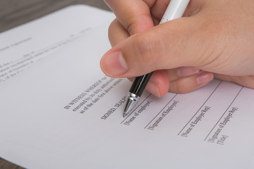 Close up of hand completing an employment application form